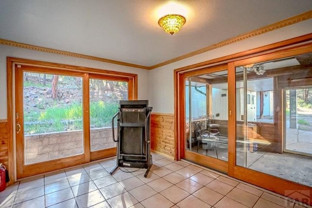 5207 N Creek Rd, Beulah, CO 81023 - entryway with healthy amount of natural light, wainscoting, light tile patterned floors, wooden walls, and ornamental molding