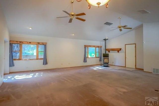 5207 N Creek Rd, Beulah, CO 81023 - unfurnished living room with a ceiling fan, a wood stove, high vaulted ceiling, carpet, and baseboards