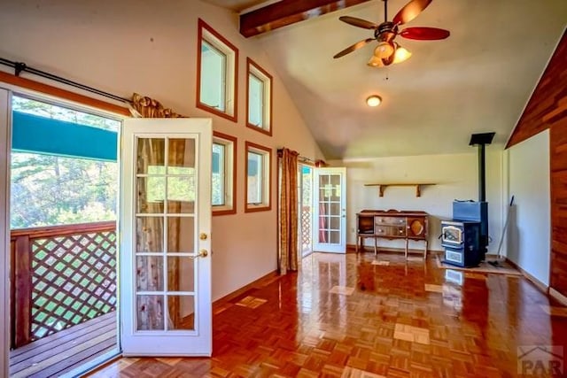 5207 N Creek Rd, Beulah, CO 81023 - living room featuring a wood stove, a ceiling fan, beamed ceiling, high vaulted ceiling, and baseboards