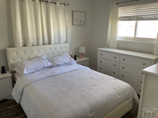 bedroom featuring dark wood finished floors