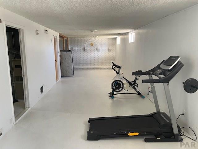 exercise room featuring a textured ceiling