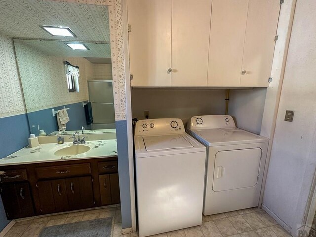 washroom with washing machine and dryer and a sink