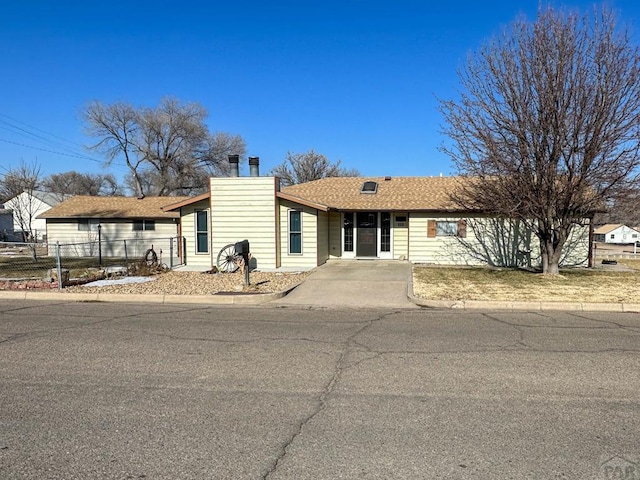 single story home with fence and a chimney