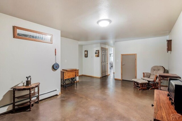 interior space with concrete floors, a baseboard radiator, and baseboards