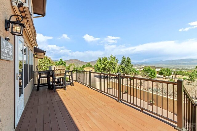 wooden deck featuring a mountain view