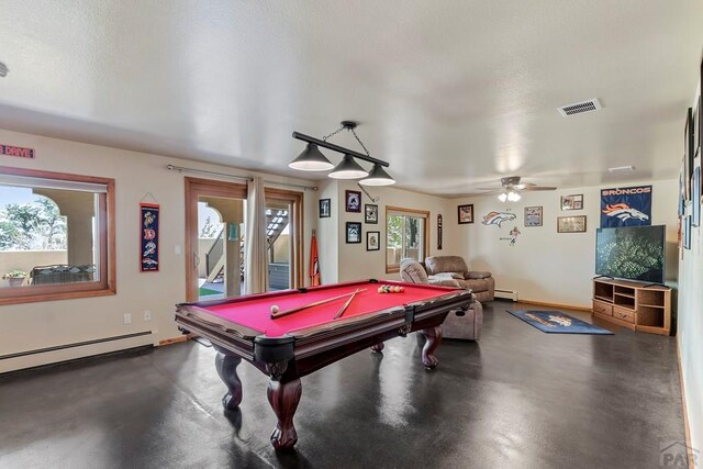 recreation room featuring concrete floors, baseboard heating, and visible vents