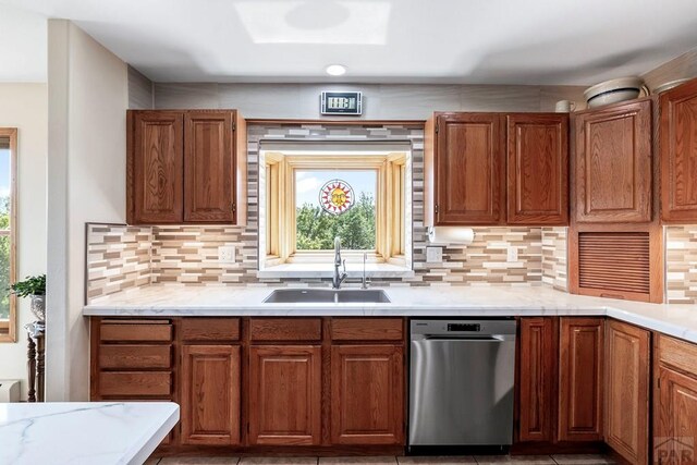 kitchen featuring tasteful backsplash, light countertops, and a sink