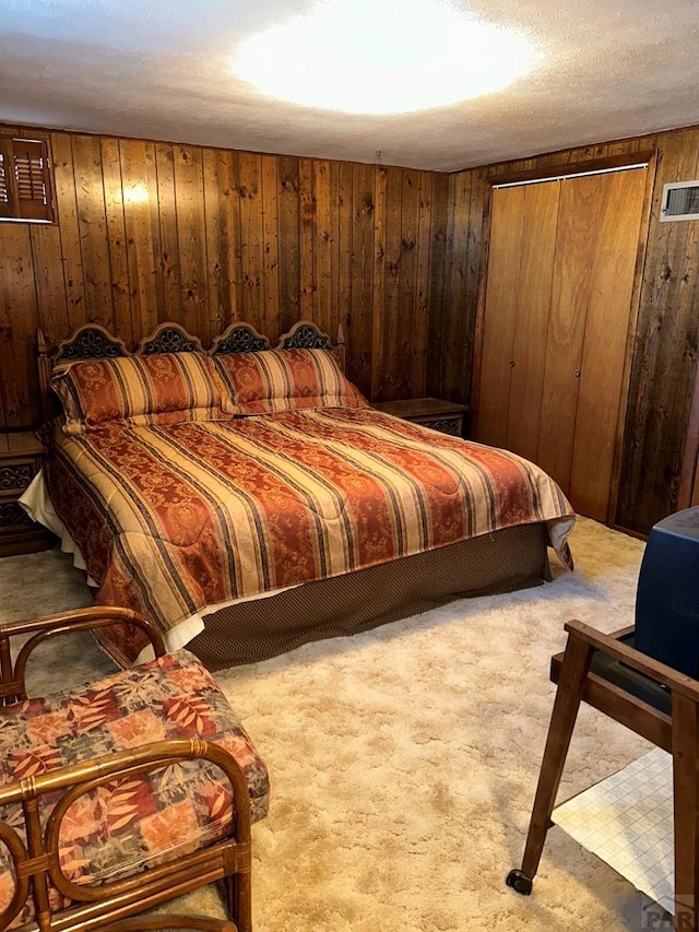 bedroom with carpet, visible vents, and wooden walls