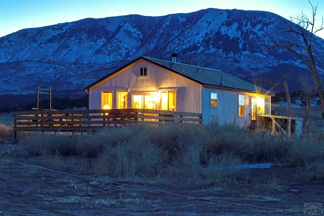 view of front of property featuring metal roof and a mountain view