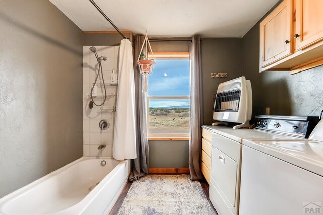 bathroom featuring separate washer and dryer, shower / bath combo, heating unit, and baseboards