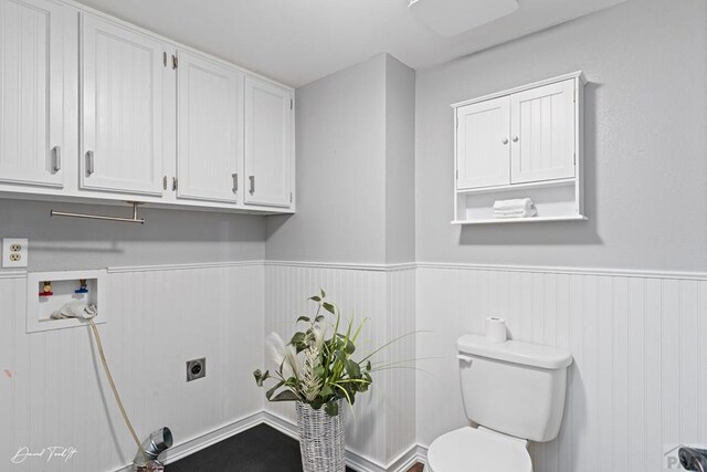 laundry room with a wainscoted wall, cabinet space, hookup for an electric dryer, and hookup for a washing machine