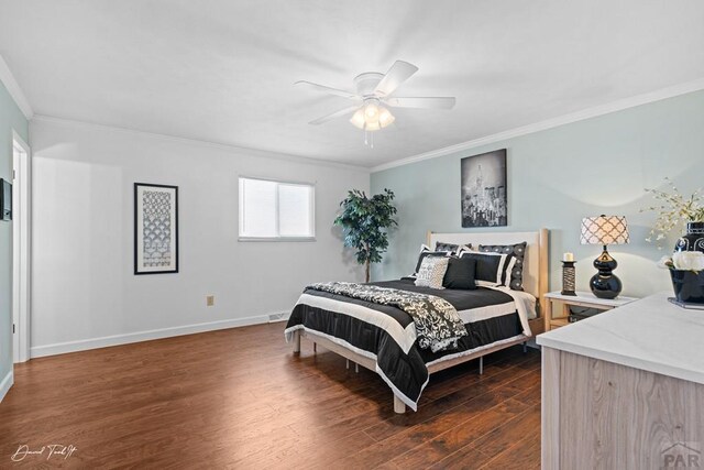 bedroom featuring dark wood-type flooring, ornamental molding, baseboards, and ceiling fan