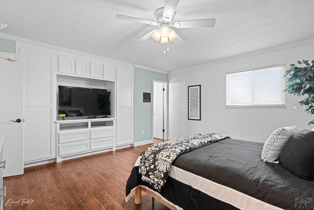 bedroom with crown molding, ceiling fan, and dark wood-type flooring