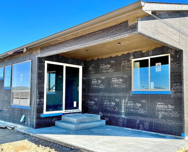 property entrance featuring brick siding