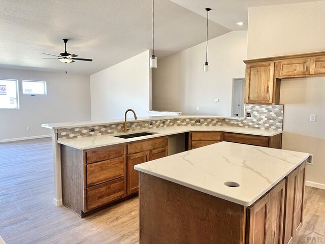 kitchen featuring lofted ceiling and light wood-style flooring