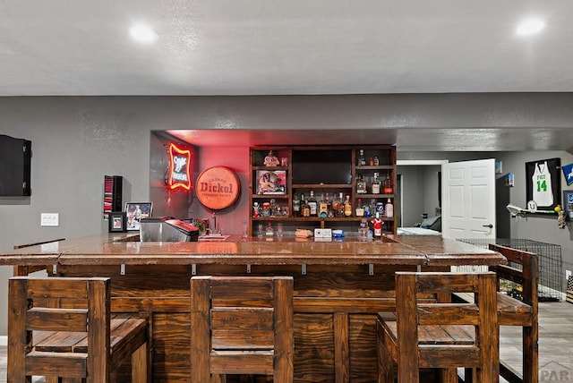 bar featuring a bar and wood finished floors