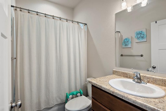 bathroom with toilet, vanity, and shower / bathtub combination with curtain