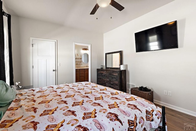 bedroom with dark wood-style flooring, a ceiling fan, visible vents, baseboards, and ensuite bath