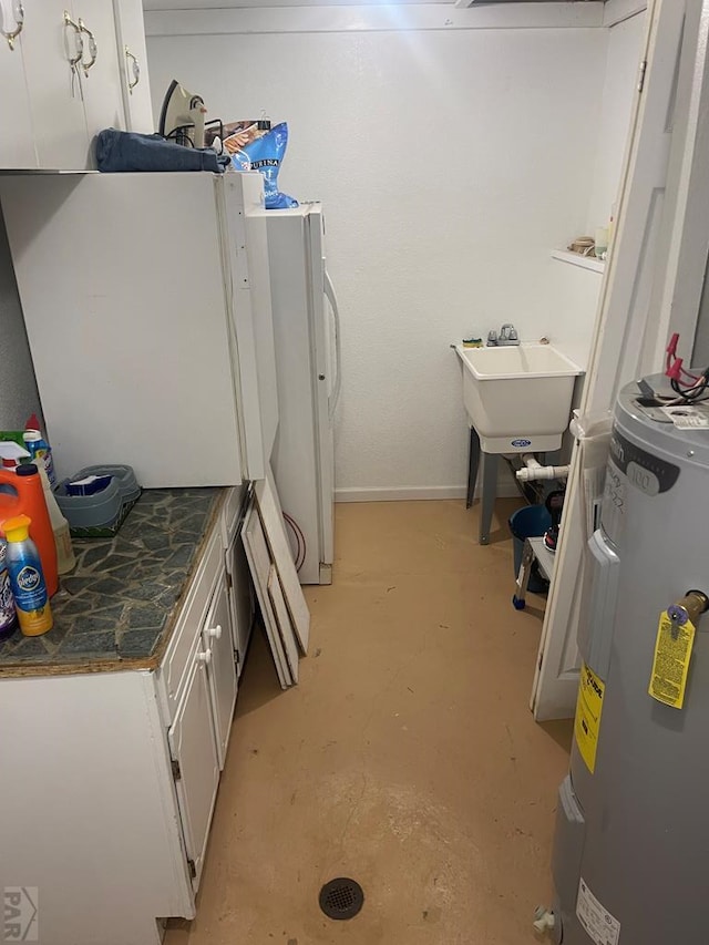 laundry room featuring a sink and electric water heater