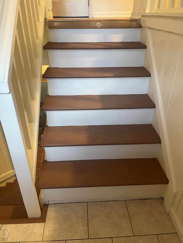 staircase featuring tile patterned floors