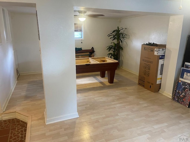 office space with light wood finished floors, ceiling fan, and baseboards