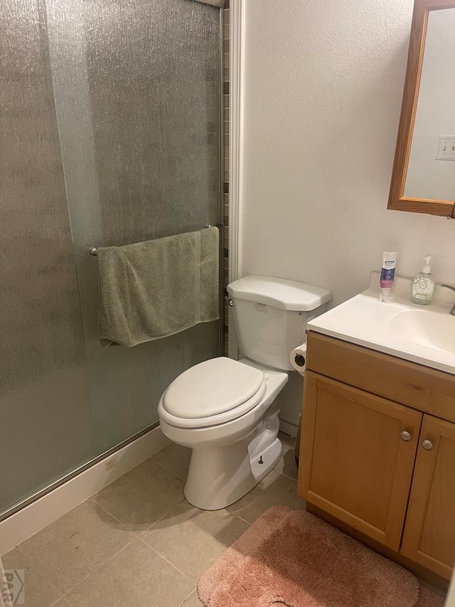 full bathroom with tile patterned floors, vanity, a shower stall, and toilet