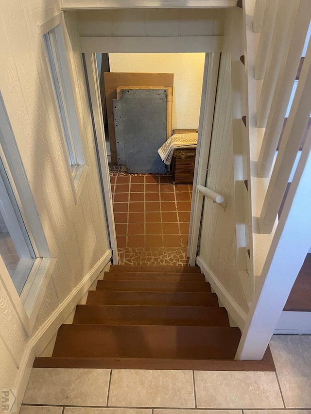 stairs featuring tile patterned flooring