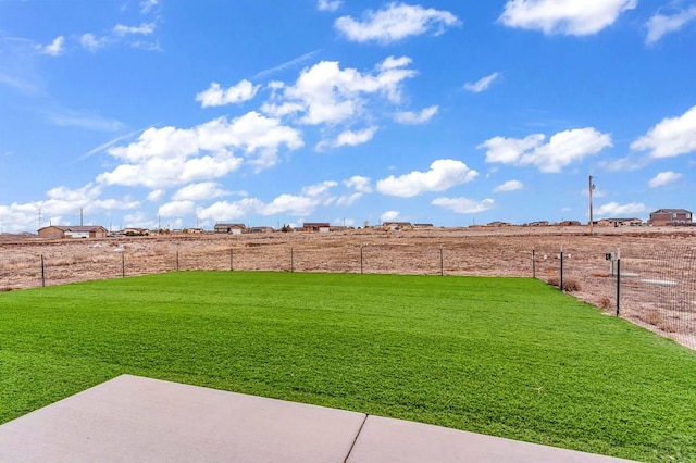 view of yard featuring fence and a rural view