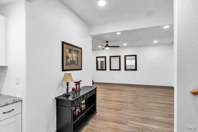 interior space featuring recessed lighting, light wood-style flooring, and baseboards