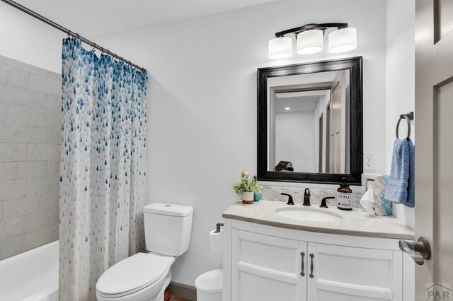 full bathroom featuring shower / bathtub combination with curtain, toilet, and vanity