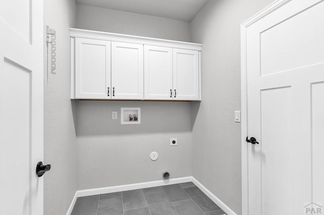 laundry area with washer hookup, hookup for a gas dryer, cabinet space, hookup for an electric dryer, and baseboards