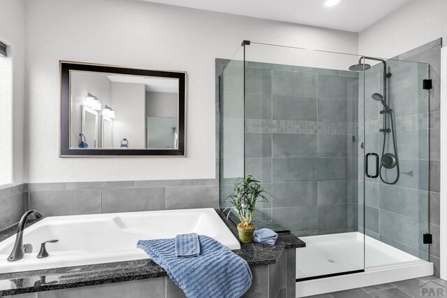 bathroom with a garden tub and a stall shower