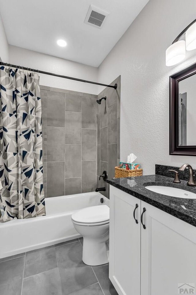 bathroom with shower / tub combo with curtain, visible vents, toilet, vanity, and tile patterned flooring