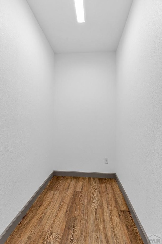 empty room featuring baseboards and wood finished floors