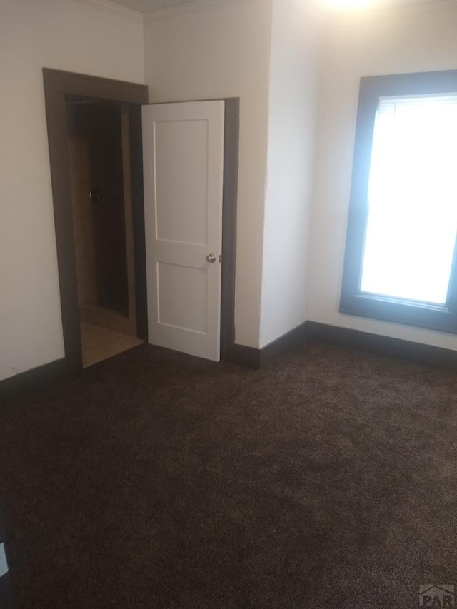 118 S 1st St, Cheraw, CO 81030 - spare room with dark colored carpet and baseboards