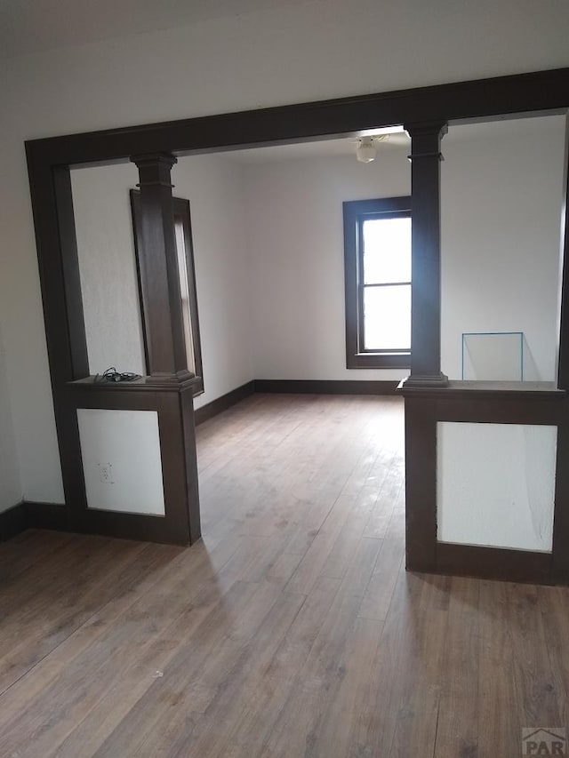 118 S 1st St, Cheraw, CO 81030 - empty room with decorative columns, wood finished floors, and baseboards