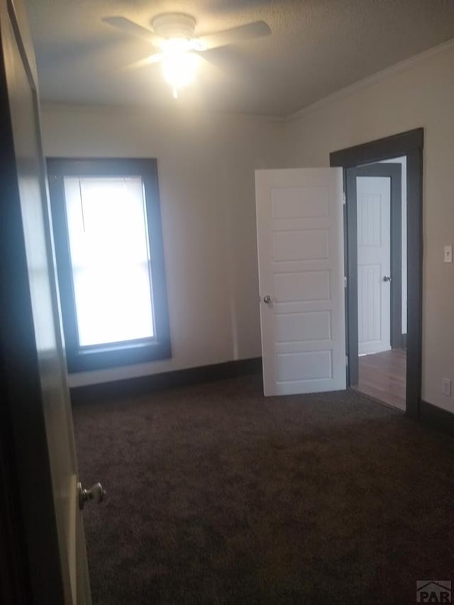 118 S 1st St, Cheraw, CO 81030 - carpeted spare room featuring ceiling fan, baseboards, and ornamental molding