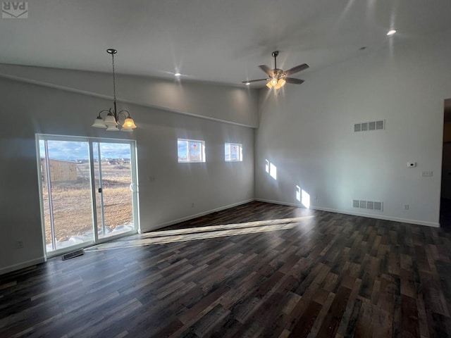 interior space with visible vents, dark wood finished floors, baseboards, and ceiling fan with notable chandelier