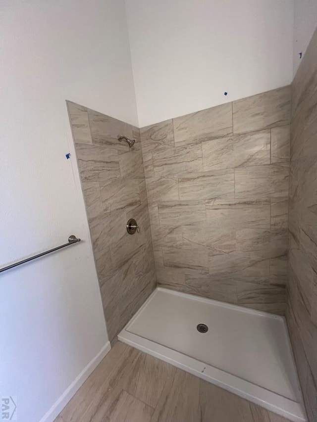 full bath featuring tiled shower