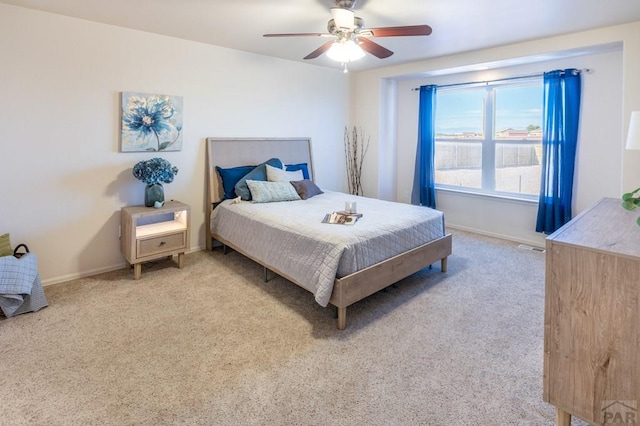 bedroom with carpet floors, a ceiling fan, and baseboards