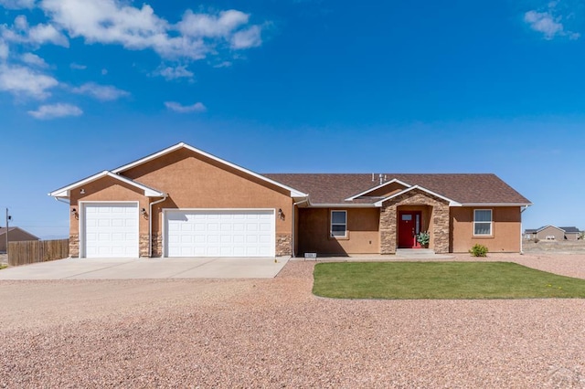 ranch-style home with stucco siding, driveway, a front yard, and a garage