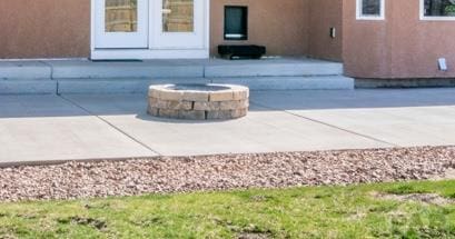 view of patio / terrace featuring a fire pit and french doors