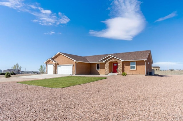 ranch-style home with concrete driveway, an attached garage, and stucco siding