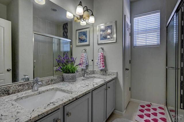 10919 Cascading Spring Cir, Peyton, CO 80831 - full bath featuring double vanity, a stall shower, tile patterned flooring, baseboards, and a chandelier