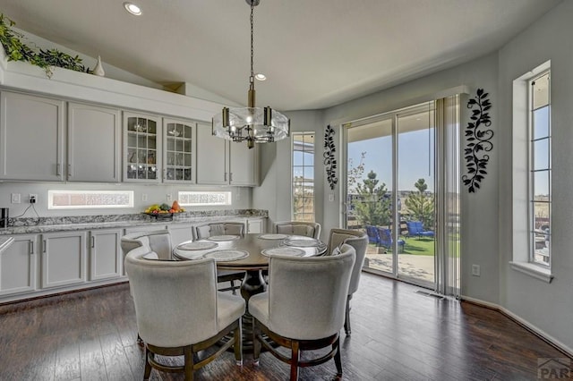 10919 Cascading Spring Cir, Peyton, CO 80831 - dining area with a chandelier, dark wood-style floors, recessed lighting, vaulted ceiling, and baseboards