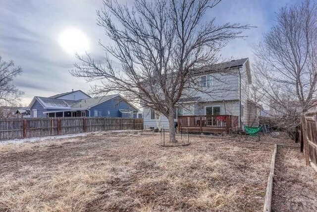 view of yard featuring a deck and a fenced backyard