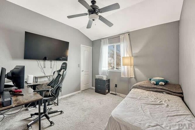 bedroom featuring ceiling fan, baseboards, vaulted ceiling, and light colored carpet