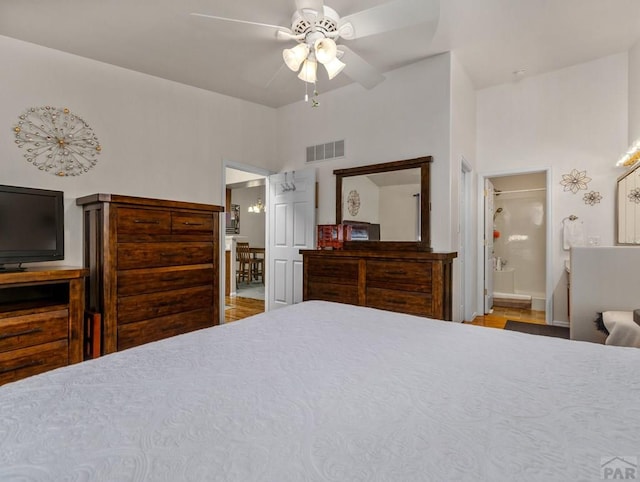 bedroom with ceiling fan, connected bathroom, and visible vents