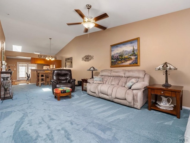 living room with carpet, vaulted ceiling, and ceiling fan with notable chandelier