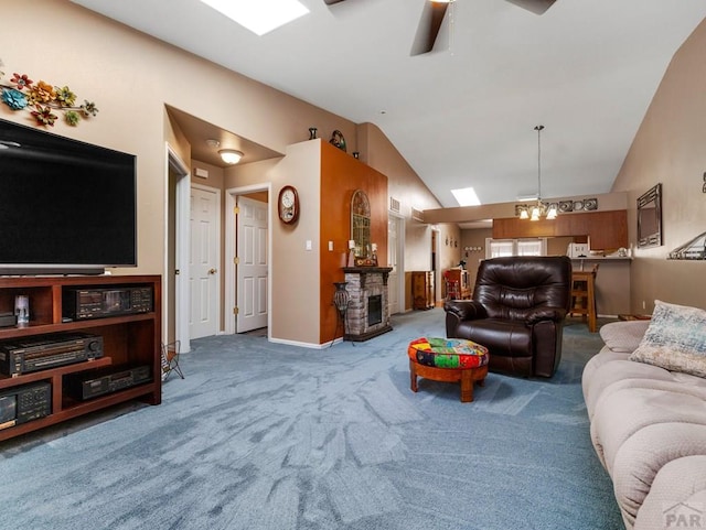 carpeted living area featuring lofted ceiling, ceiling fan with notable chandelier, and baseboards